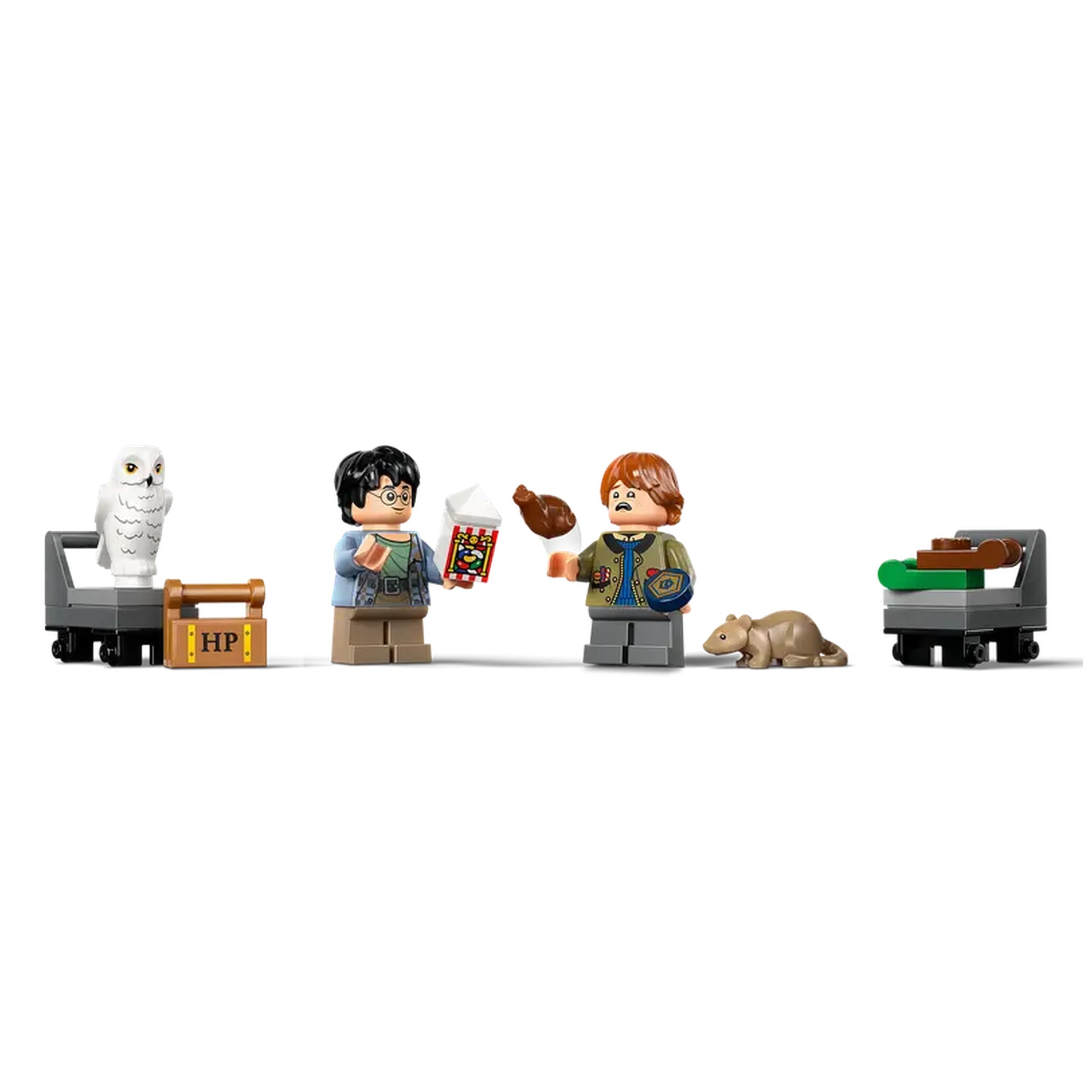 LEGO Harry Potter minifigures of Harry and Ron, with Hedwig the owl and Scabbers the rat, hold items at King's Cross Station.