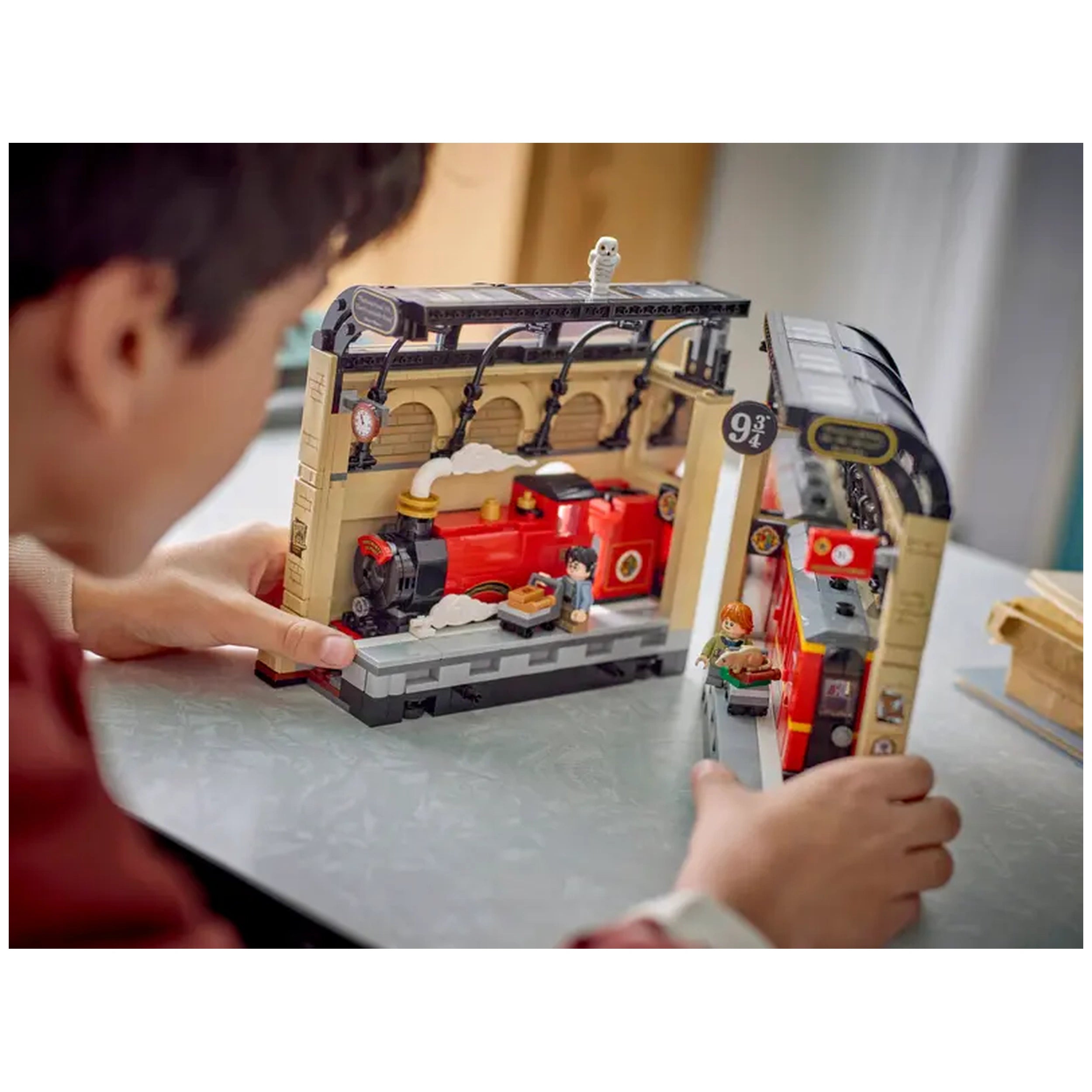 LEGO Harry Potter Book Nook featuring the Hogwarts Express, with Harry and Ron minifigures beside a detailed locomotive on a table.