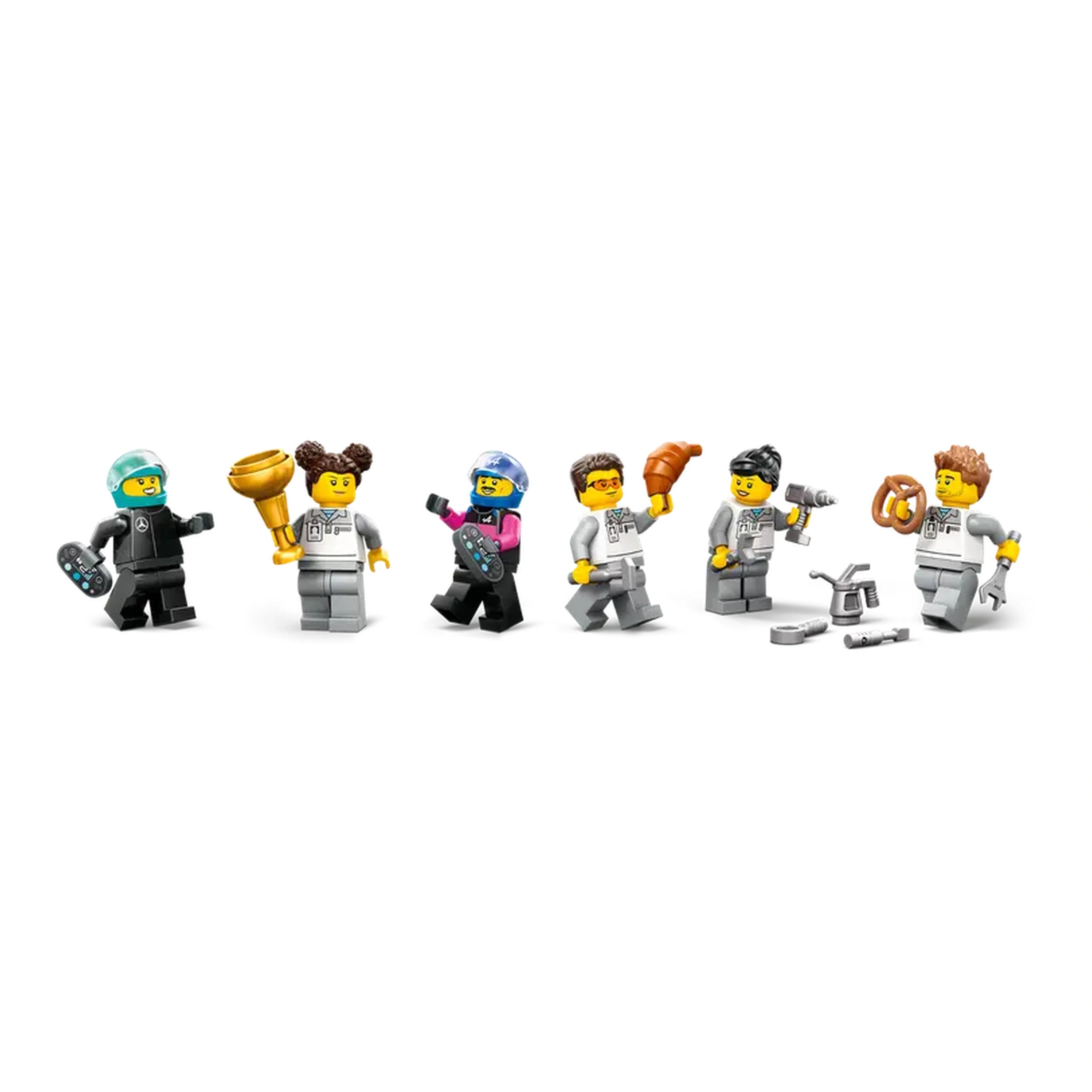 Six LEGO mini-figures in racing gear celebrate in the F1 garage, holding tools, a trophy, and a pretzel, showcasing teamwork and excitement.