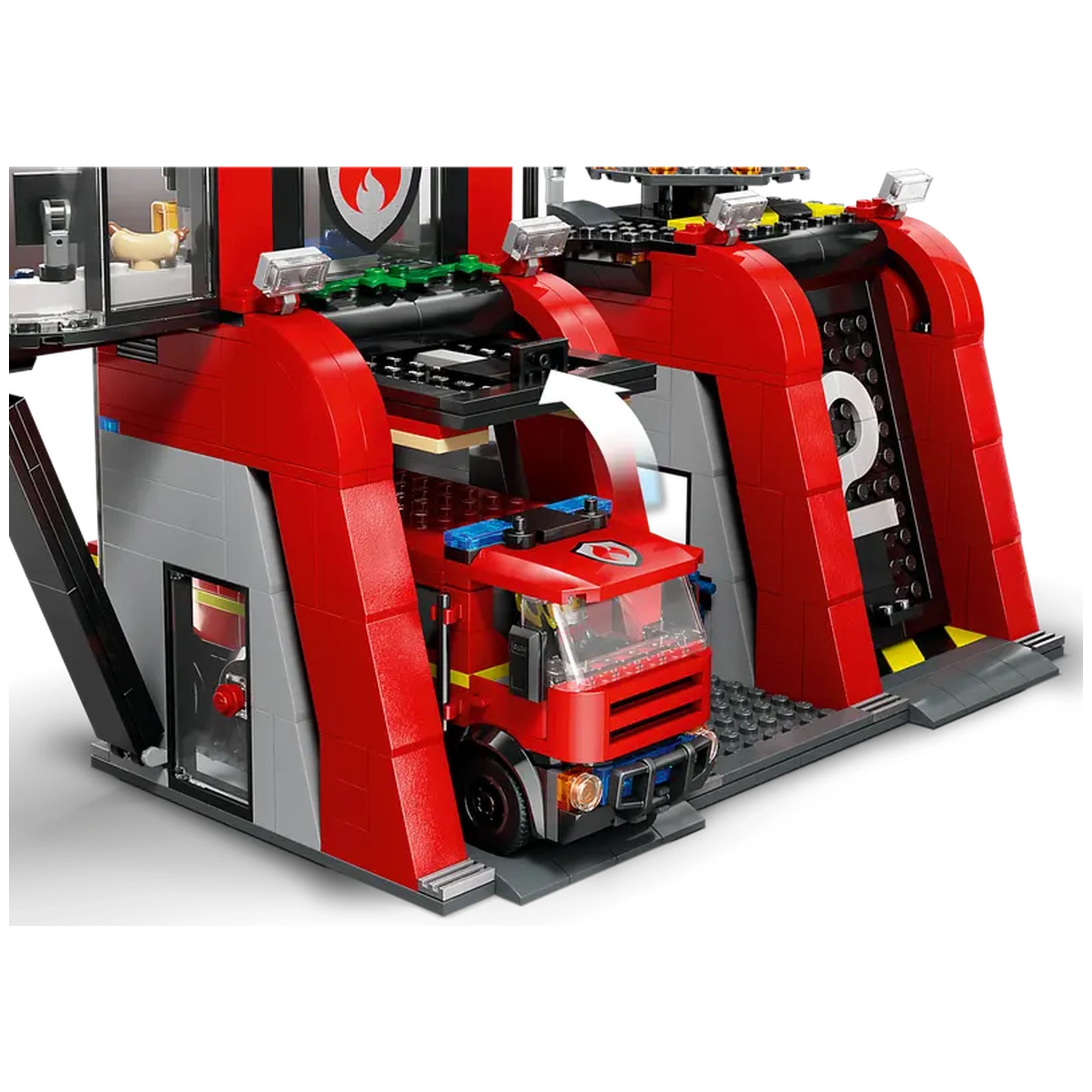 LEGO City Fire Station with a red fire truck parked in a garage, featuring a modern design with tall arches and a control center.
