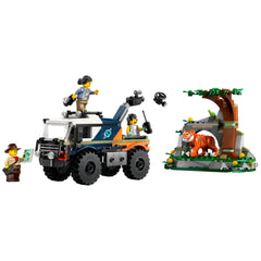 LEGO City Jungle Explorer Off-Road Truck construction set featuring a rugged truck with oversized tires, two explorer minifigures, and a vibrant jungle cave scene with a LEGO tiger. One figure holds a map, while another operates a camera boom.