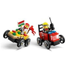 Chef in a pizza slice race car holding a "Pizza" sign, facing a firefighter in a red fire truck. Both cars have four wheels.