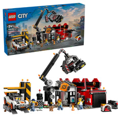 LEGO City Scrapyard construction set featuring a claw crane, colorful buildings, and mini-figures interacting with cars.