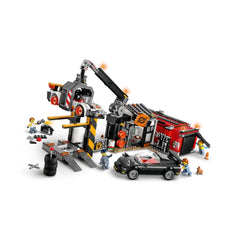 LEGO City Scrapyard construction set featuring a claw crane lifting a toy car, with two classic cars and three minifigures.