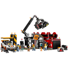 LEGO® City Scrapyard construction set featuring a claw crane hoisting a car, colorful buildings, and playful minifigures with a dog.