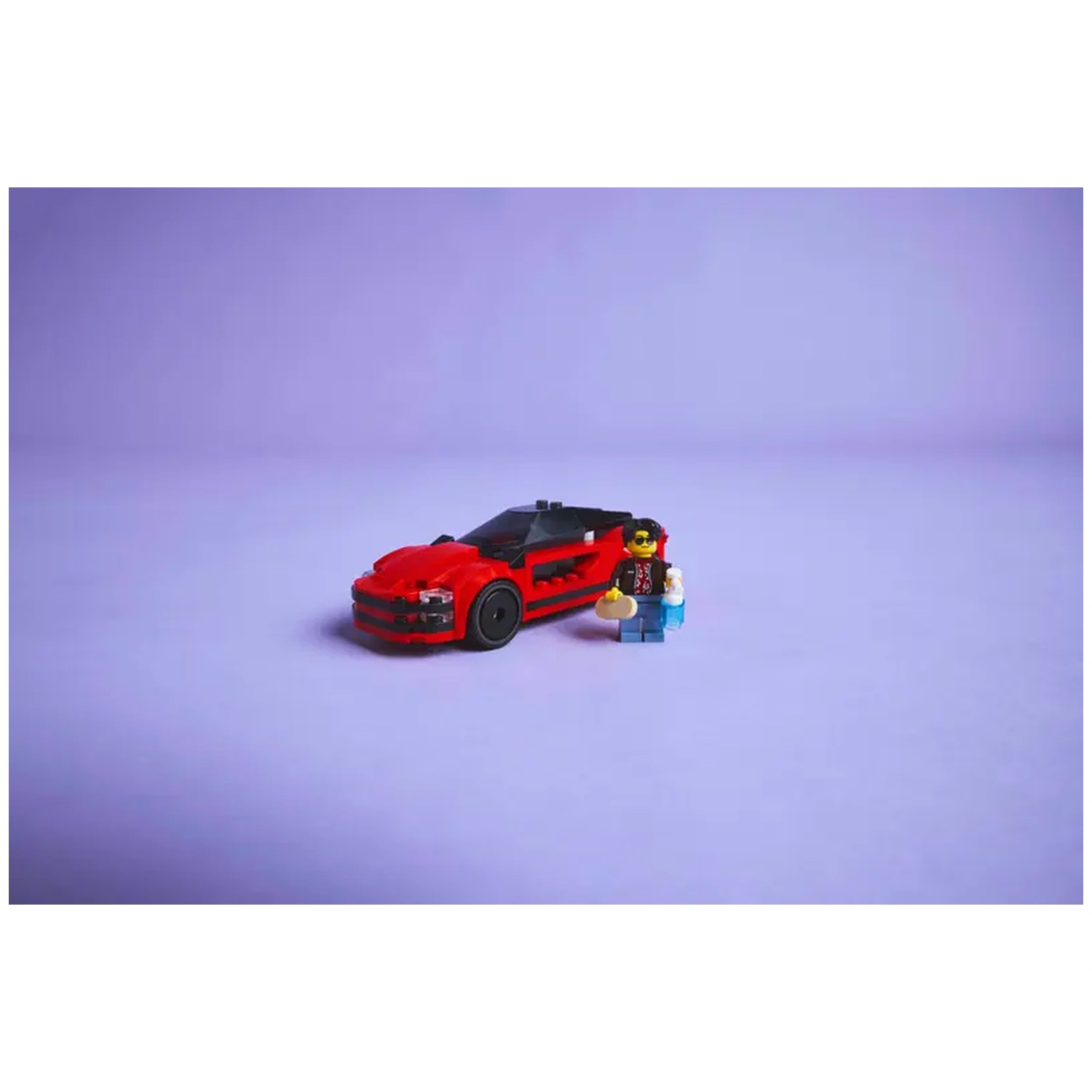 Red LEGO® City sports car with sleek design, featuring black rims and tinted cockpit, alongside a driver minifigure holding accessories.