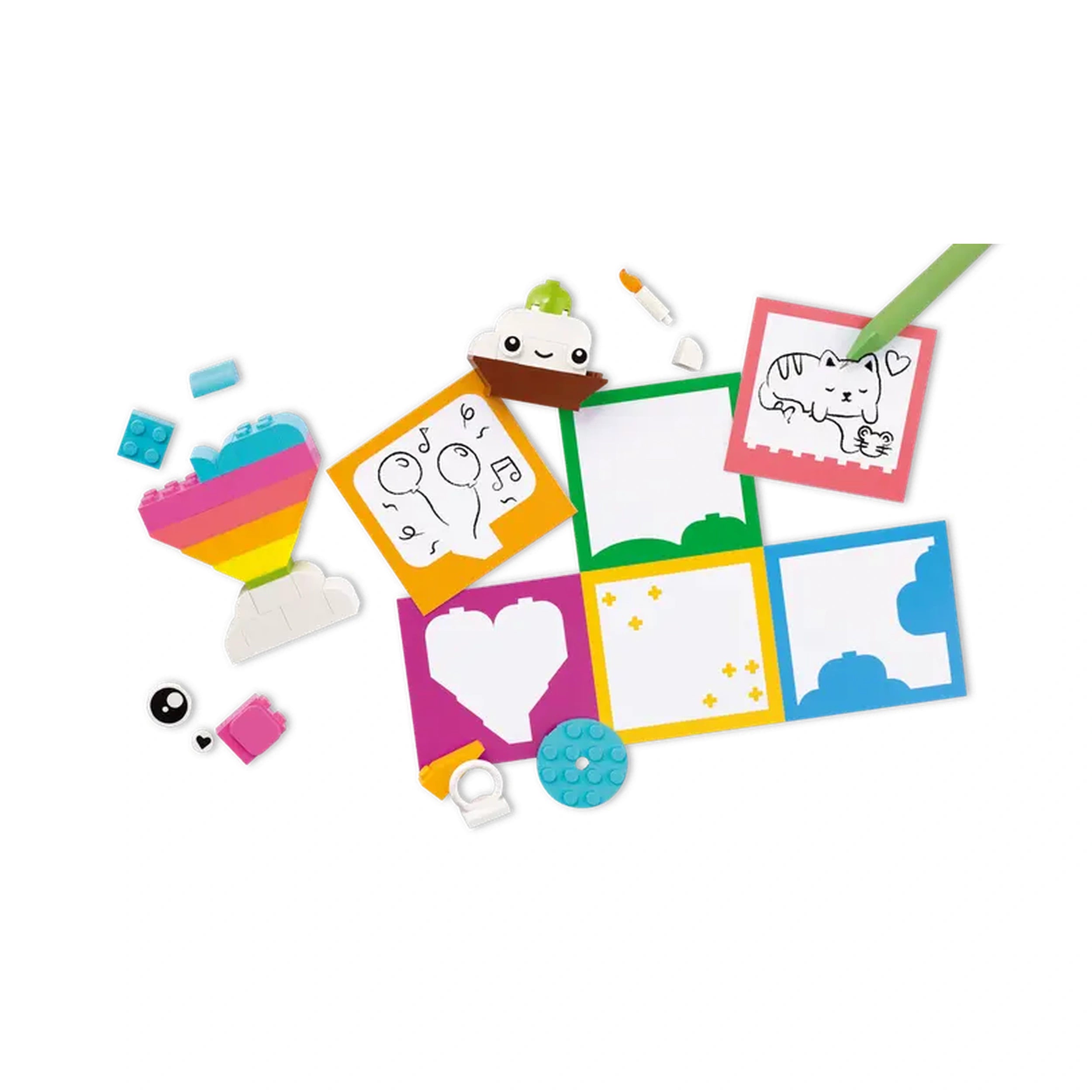 Colorful LEGO® bricks and playful building elements scattered around various blank and illustrated cards, including a fun drawing of a cat and a cupcake design.