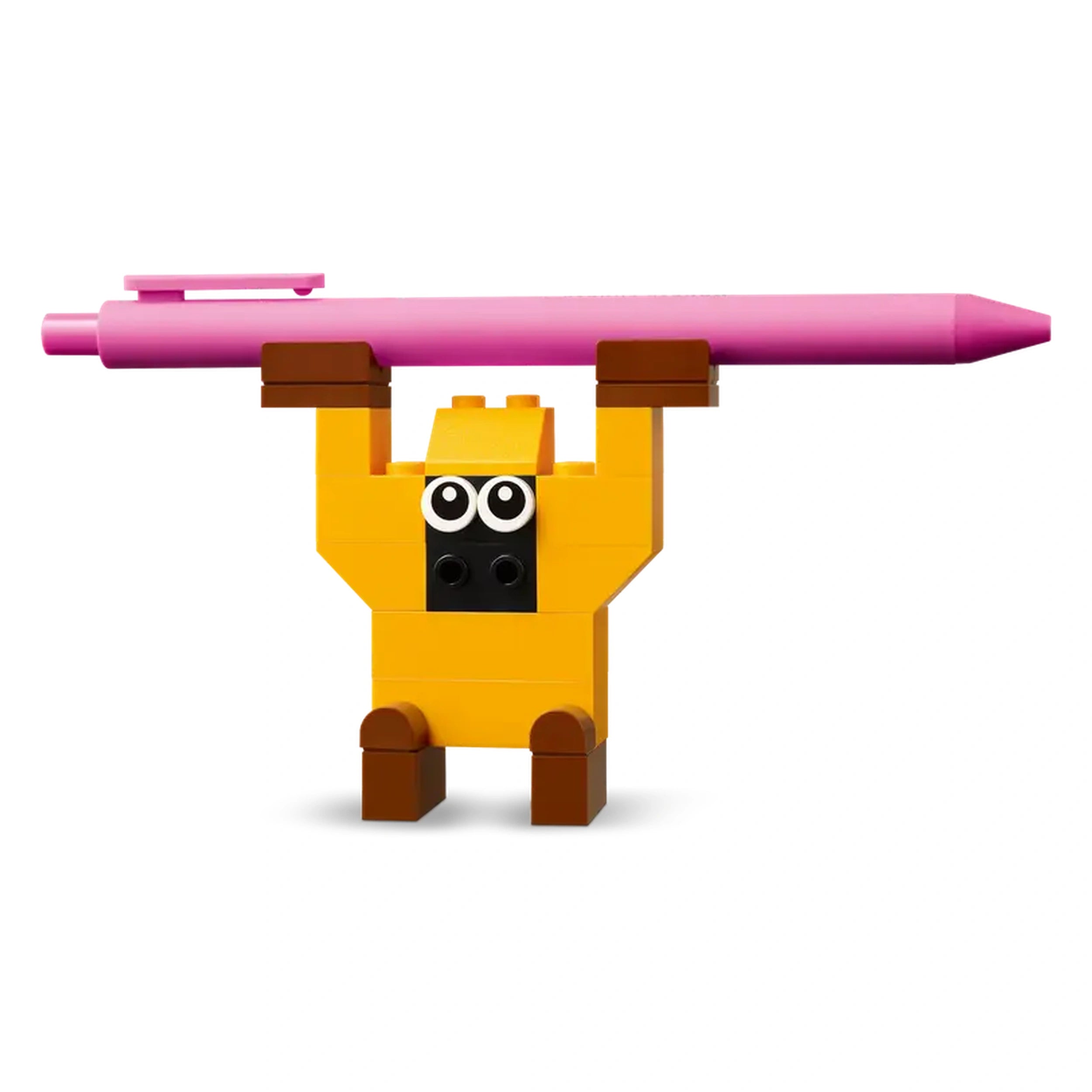 A cheerful yellow LEGO character raises a pink crayon overhead, featuring large white eyes and brown legs, against a plain white background.