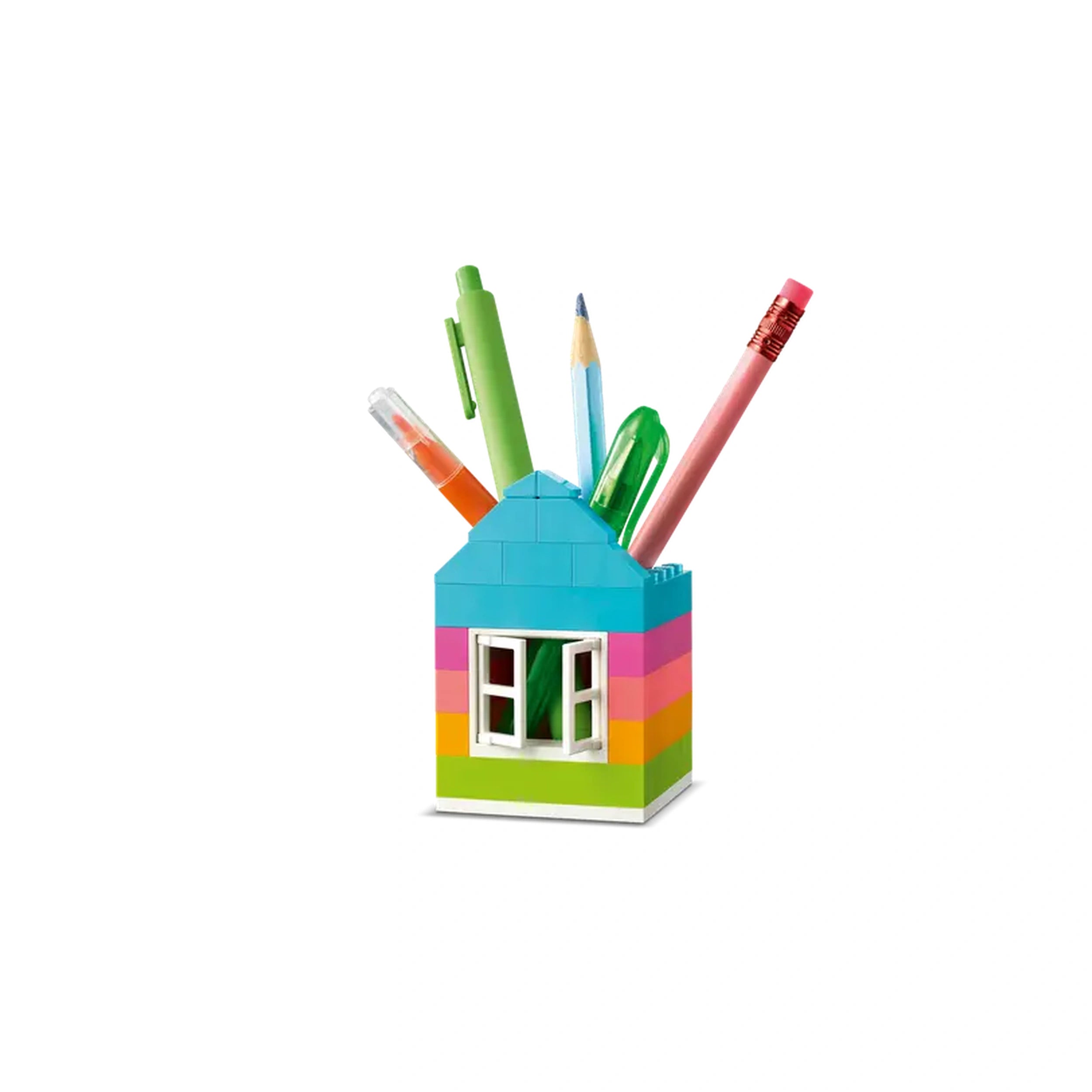 Colorful LEGO® house-shaped pencil holder filled with various writing tools, including pens and pencils, against a plain background.