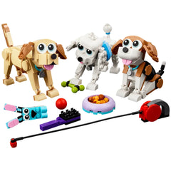 Three LEGO dogs, a beagle, a poodle, and a Labrador, are surrounded by colorful accessories including a food bowl, a ball, and a leash. The dogs have playful expressions, with posable heads and tails.