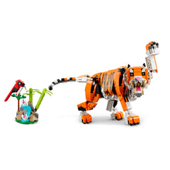 Posable LEGO® Creator 3in1 Majestic Tiger in vibrant orange and black, roaring with a raised paw, next to a colorful red bird and palm trees.