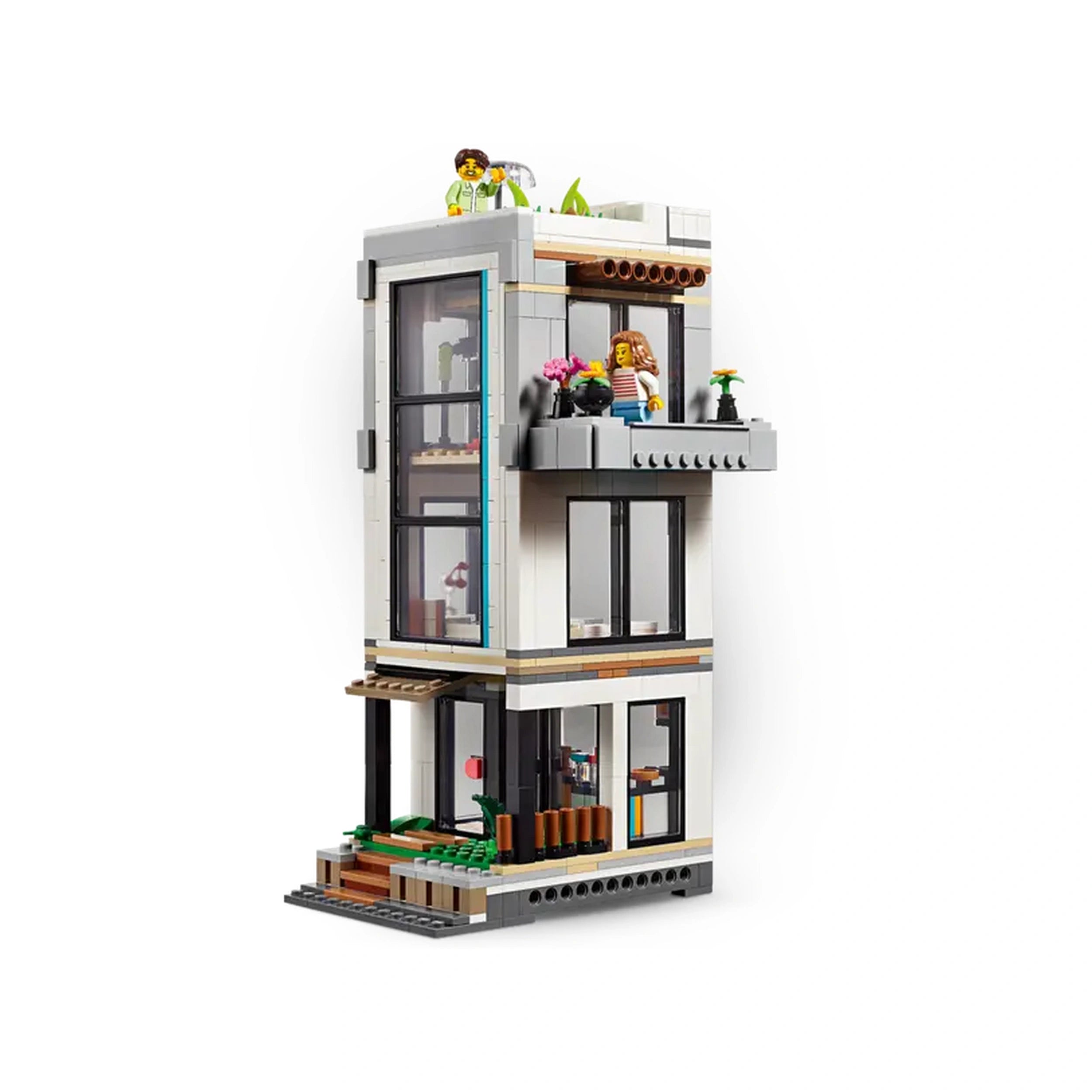 Modern LEGO Creator construction set featuring a stylish three-story house with large windows, a balcony, and green plants.