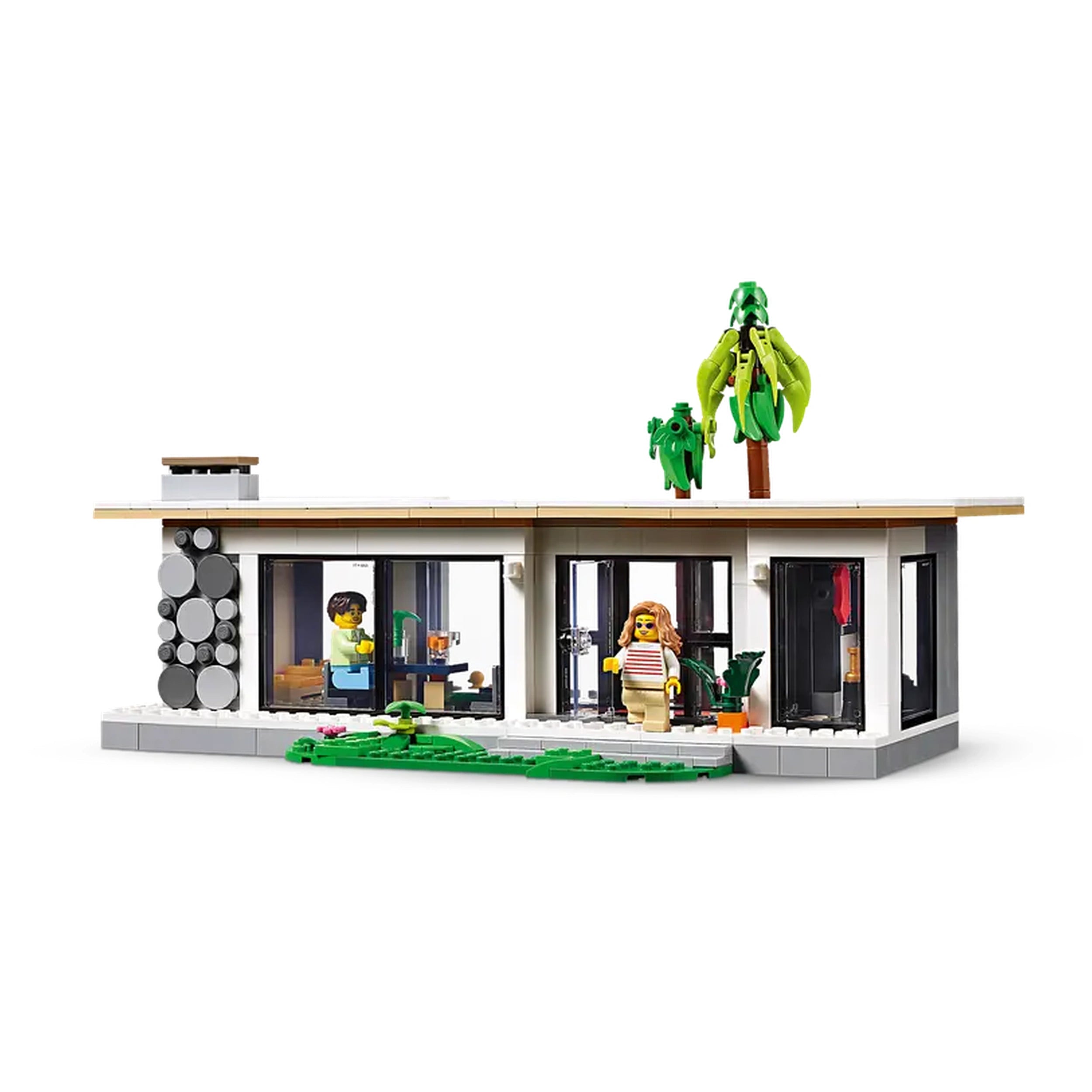 Modern LEGO Creator beach house model featuring two palm trees, an outdoor patio, and interior rooms with colorful furnishings.