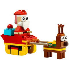 Colorful LEGO construction set featuring Santa in a red sleigh with festive decorations, pulled by a cheerful brown reindeer.