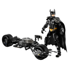 Fully posable Batman figure in a black suit and cape stands next to the Bat-Pod bike, showcasing intricate details.