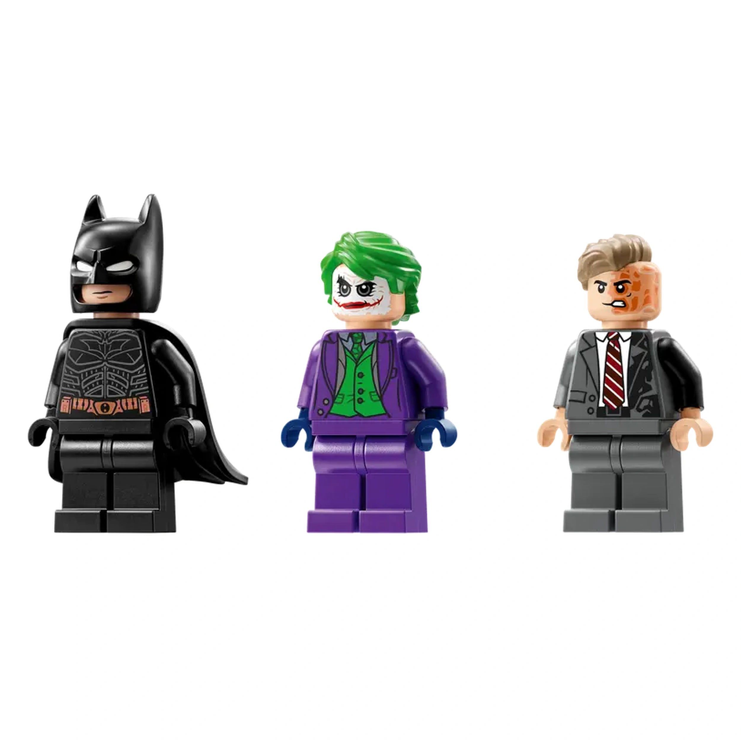 Three LEGO minifigures: Batman in a black suit with a cape, the Joker in a purple suit with green hair, and Two-Face in a gray suit with a disfigured face, standing side by side.