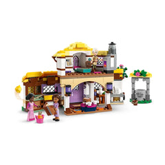 Asha’s Cottage construction set features a colorful, two-level cottage with hinged sides, two figures, and a wishing well.