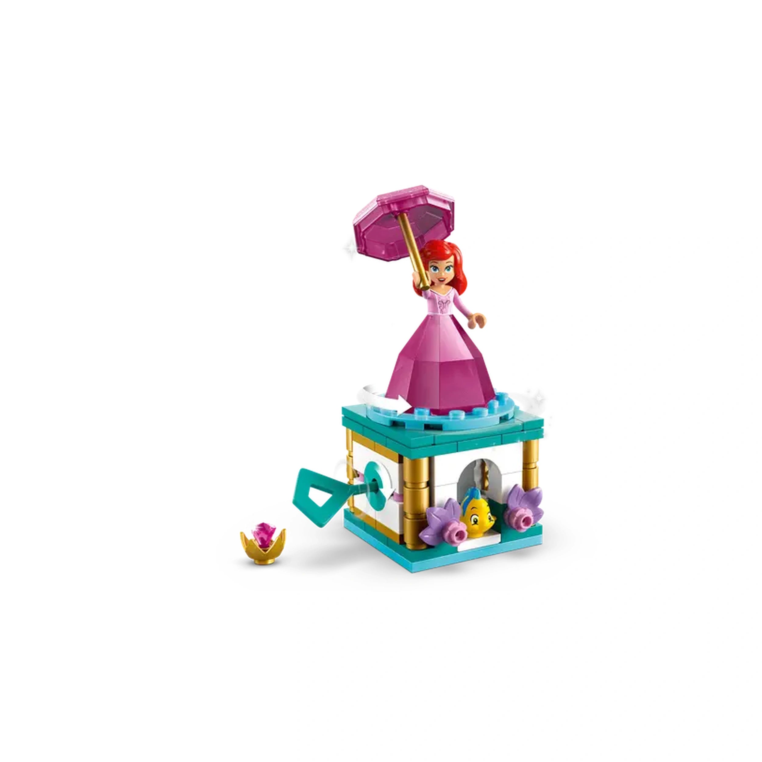 Twirling Ariel construction set featuring a mini-doll in a pink dress holding an umbrella atop a colorful stand, with Flounder nearby.