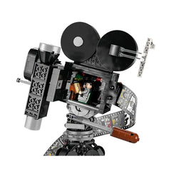 LEGO® Disney Tribute Camera featuring a vintage movie camera design, with a hinged back revealing a minifigure and film strip showcasing iconic Disney scenes.