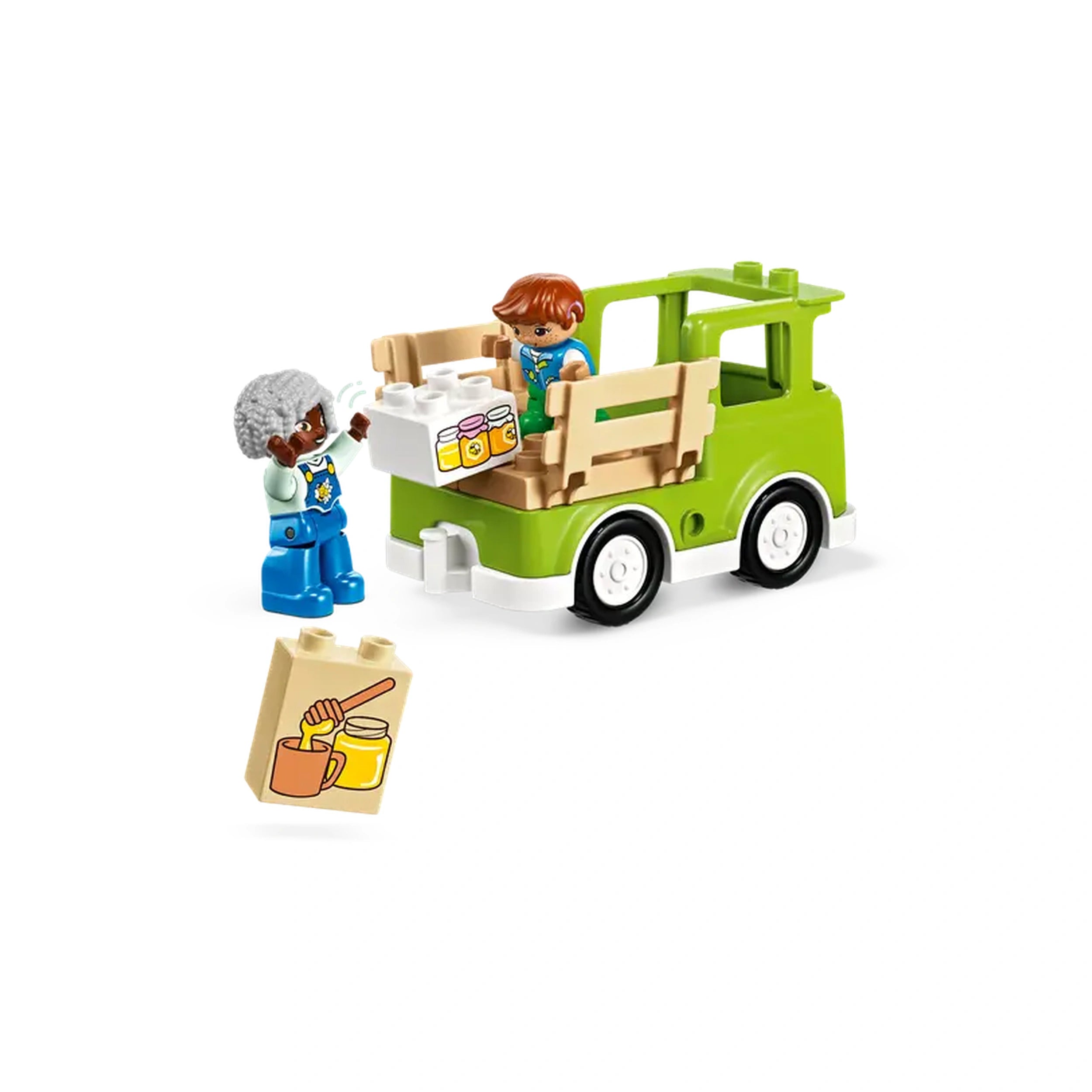 Two colorful LEGO® DUPLO® figures interact with a green truck, loading honey jars. A honeycomb-themed block is nearby.