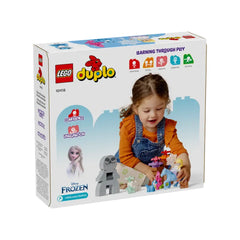 A young girl joyfully assembles the LEGO® DUPLO® Disney Elsa & Bruni set, featuring colorful pieces and a whimsical forest scene.