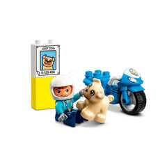 A playful police officer figure in blue attire sits next to a cute beige dog, beside a yellow ‘lost dog’ sign and a blue police motorcycle.
