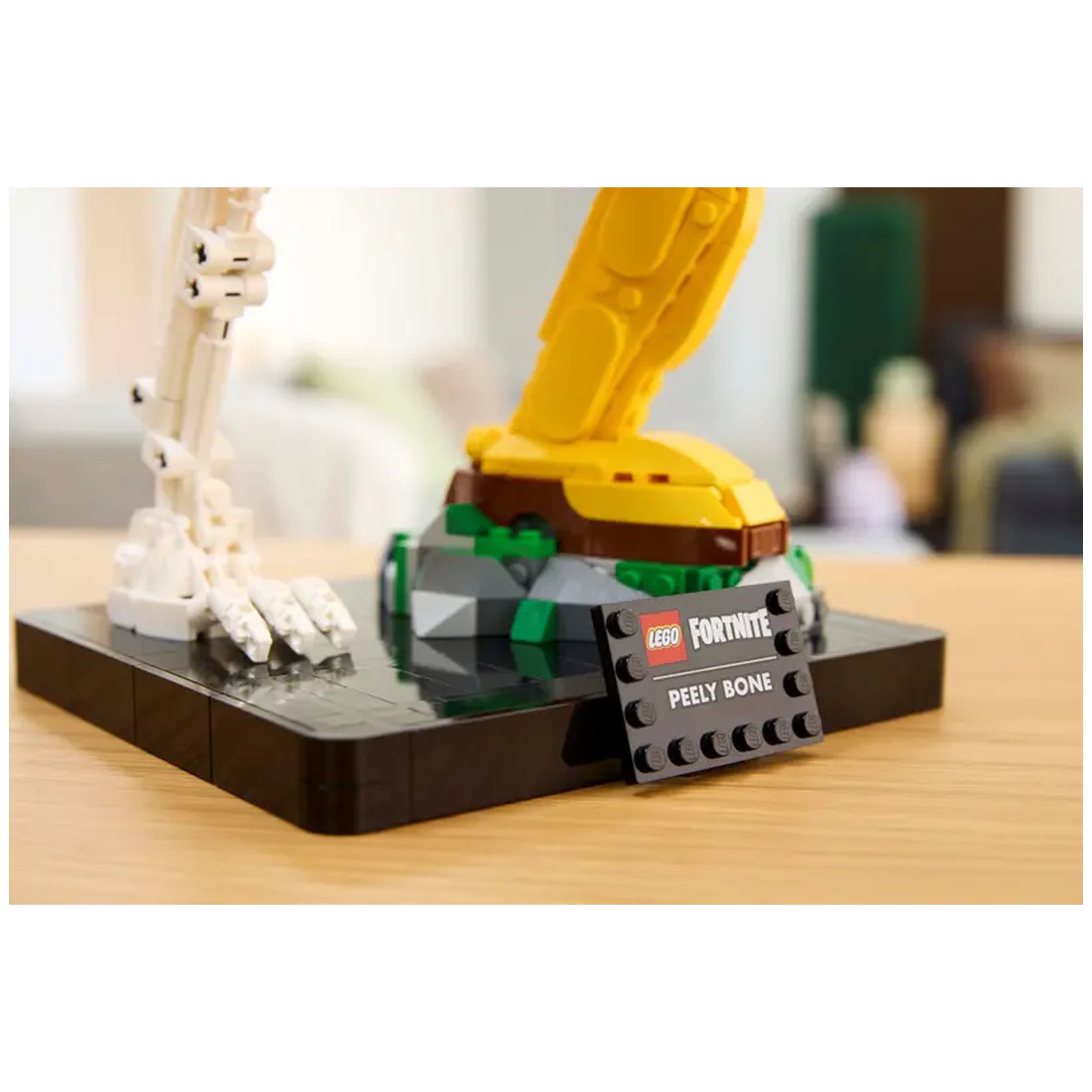 LEGO Fortnite Peely Bone construction set featuring a yellow banana skeleton with a black base, including a display plaque.