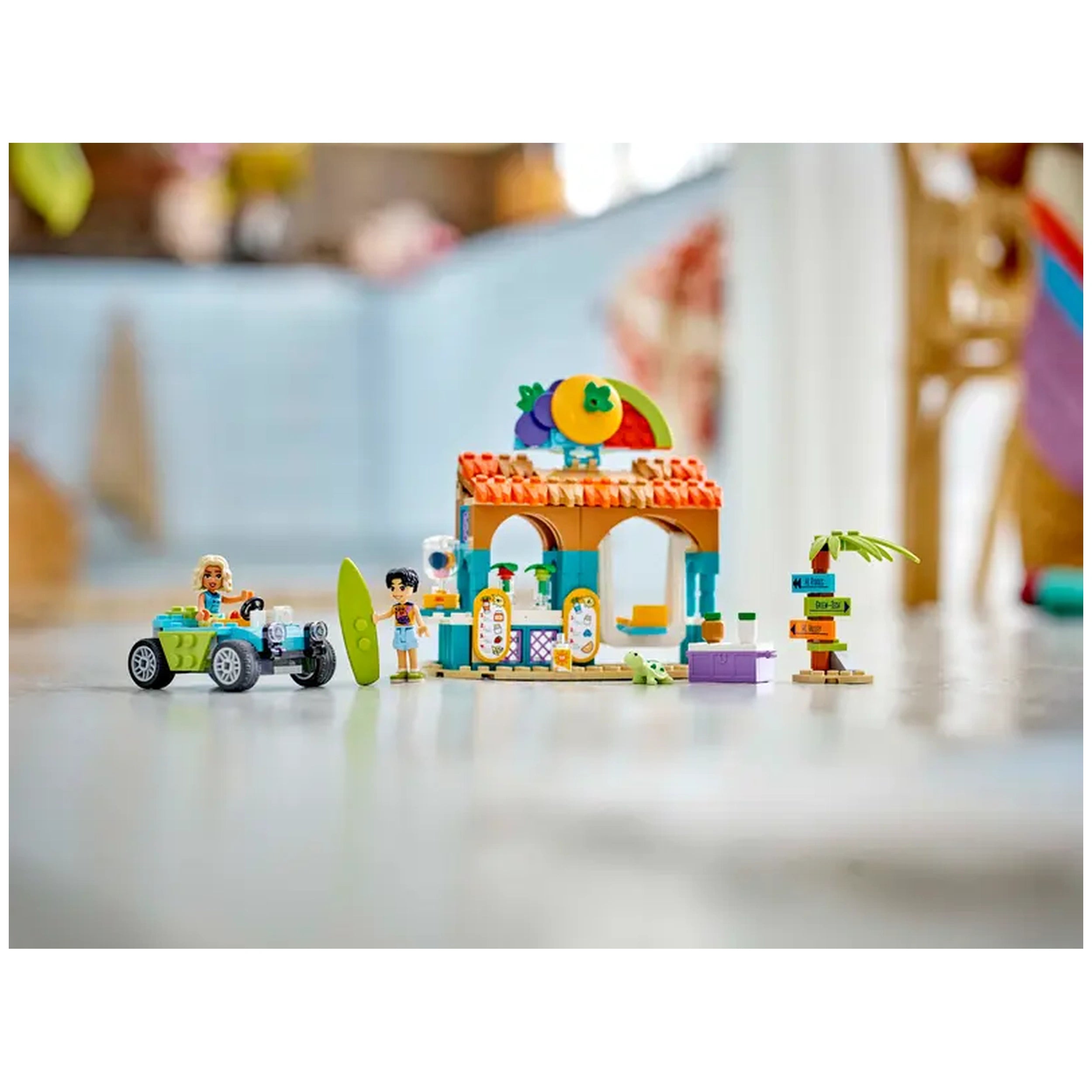 Colorful LEGO Friends Beach Smoothie Stand set featuring a smoothie stall, beach buggy, mini-dolls Nova and Niko, and accessories.
