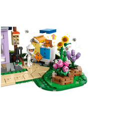 LEGO Friends Beekeepers’ House and Flower Garden set, featuring a vibrant flower garden with pink and yellow flowers, a beehive, and a minidoll dressed as a beekeeper. Bees are buzzing around, adding life to the colorful scene.
