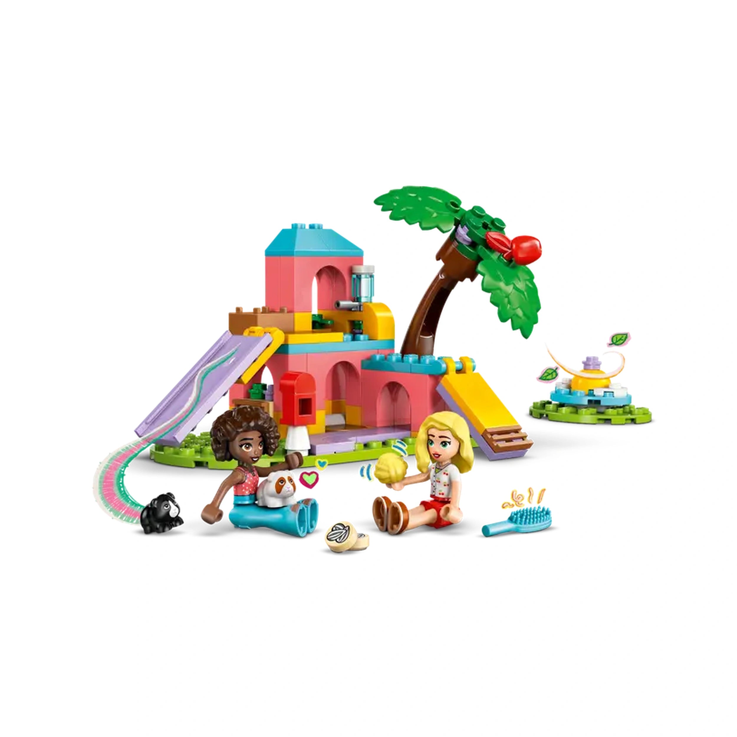 Two LEGO Friends minidolls sit with guinea pigs beside a colorful playground, featuring a slide and tree, inviting imaginative play.
