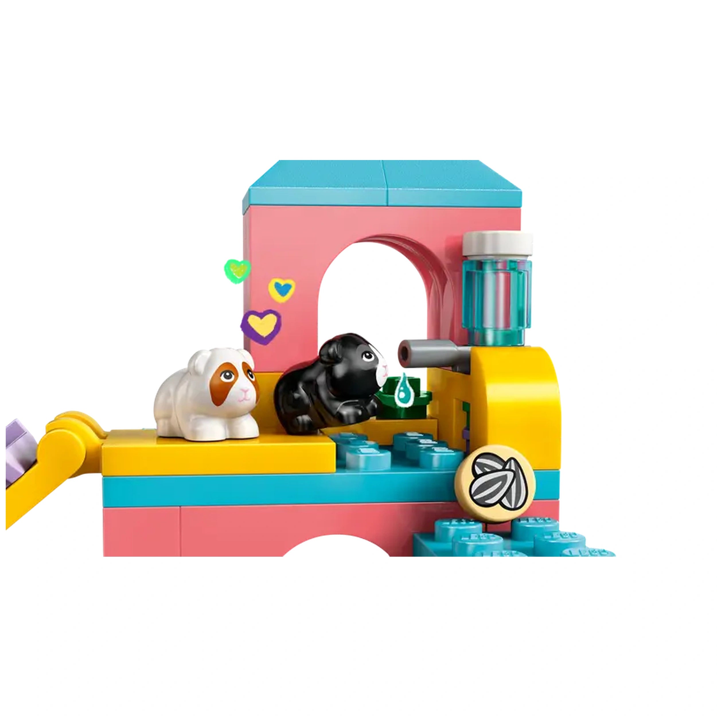 Two colorful LEGO pieces form a guinea pig playground with a white and brown guinea pig beside a black guinea pig, playful elements, and heart decorations.