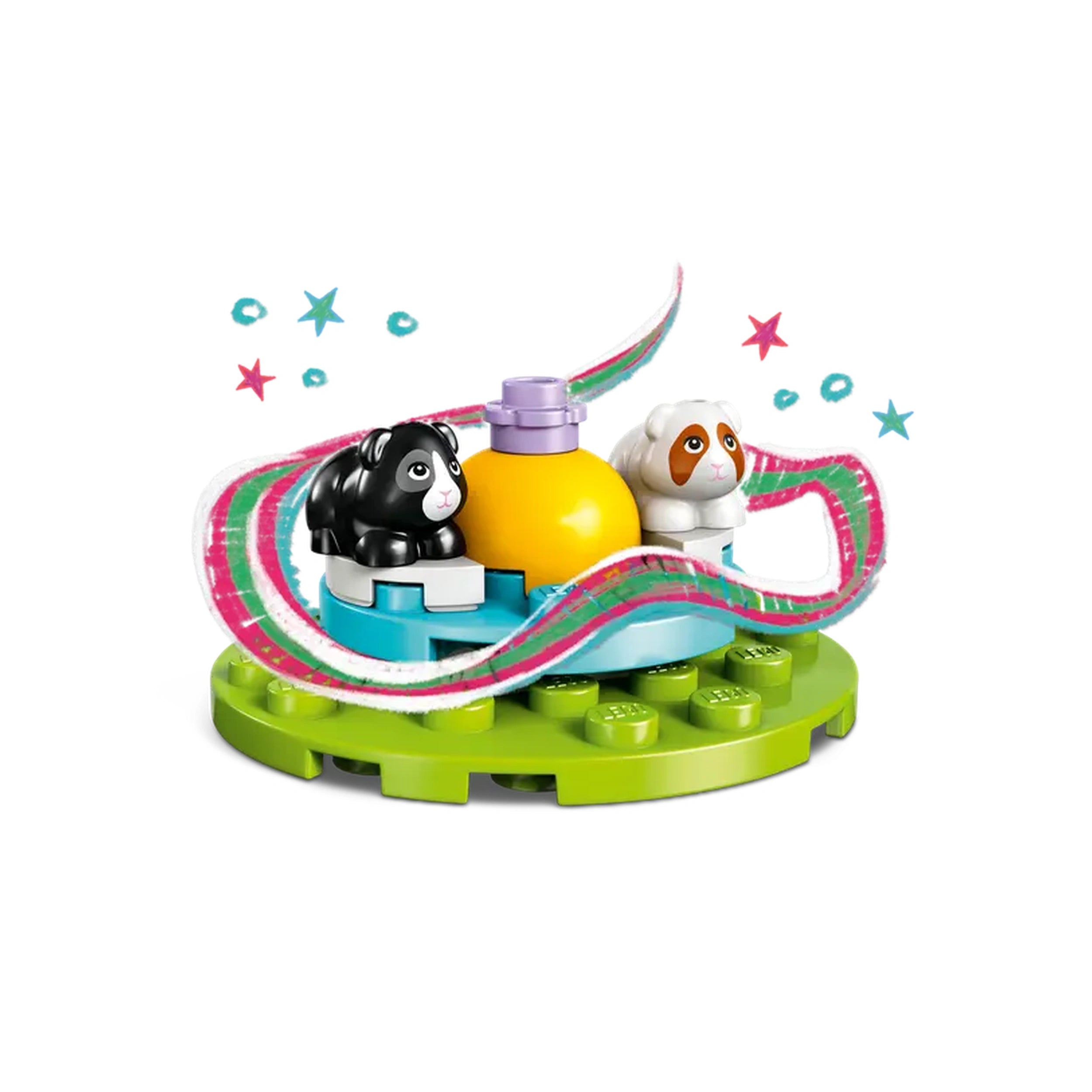 Two LEGO guinea pig figures, one black and one tan, sit on a circular green base. A yellow food bottle is centered between them, with colorful decorations swirling around, adding a playful touch.