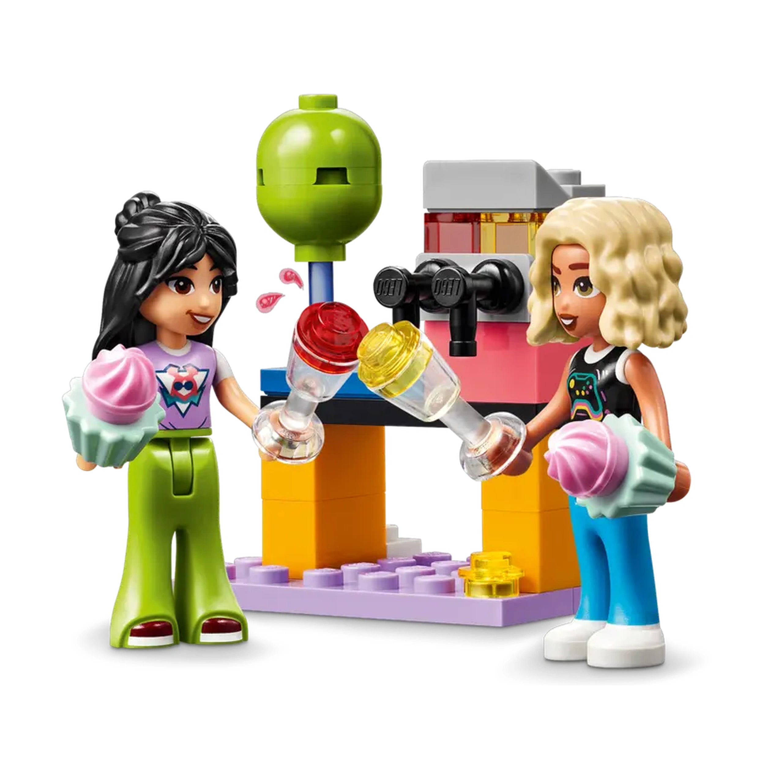 Two LEGO Friends figures joyfully hold colorful microphones and ice cream cupcakes, ready for a karaoke party. Behind them, a vibrant stage with a revolving design and a drink station adds to the festive atmosphere.