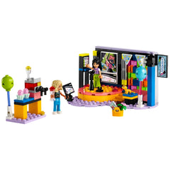 A colorful LEGO® Friends Karaoke Music Party set featuring two characters on a revolving stage, surrounded by playful decor, microphones, and a snack stand with ice cream.
