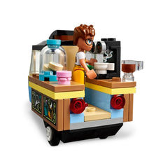 LEGO Friends Mobile Bakery Food Cart with vibrant colors, featuring a mini-doll, Aliya, preparing treats and a miniature coffee cup on the counter.