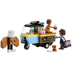 LEGO Friends Mobile Bakery Food Cart with two mini-dolls, Aliya and Jules, and a playful dog figure, Aira, serving treats from a colorful cart.