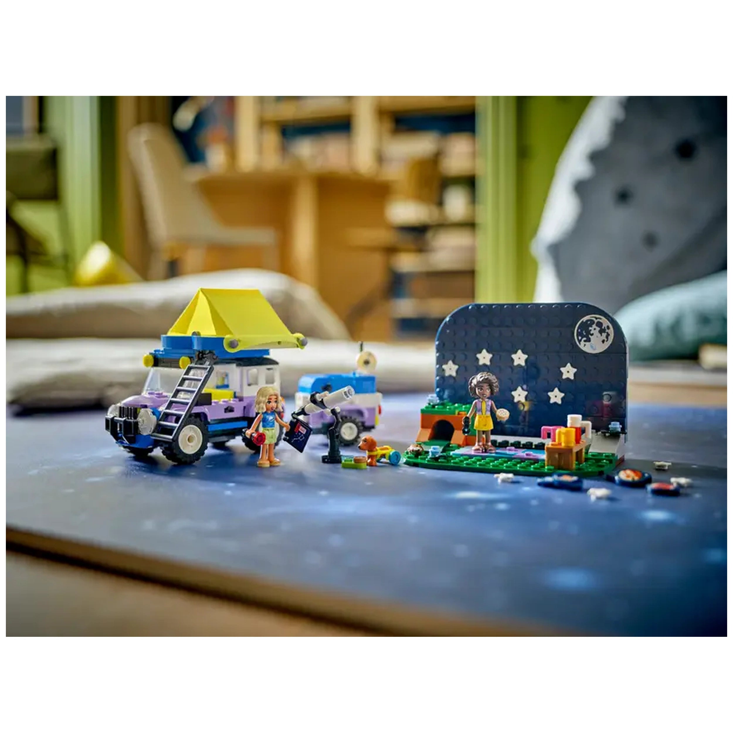 Colorful LEGO Friends camping set featuring a 4x4 vehicle, two mini-dolls, a dog figure, a telescope, and a starry backdrop, inviting imaginative play.