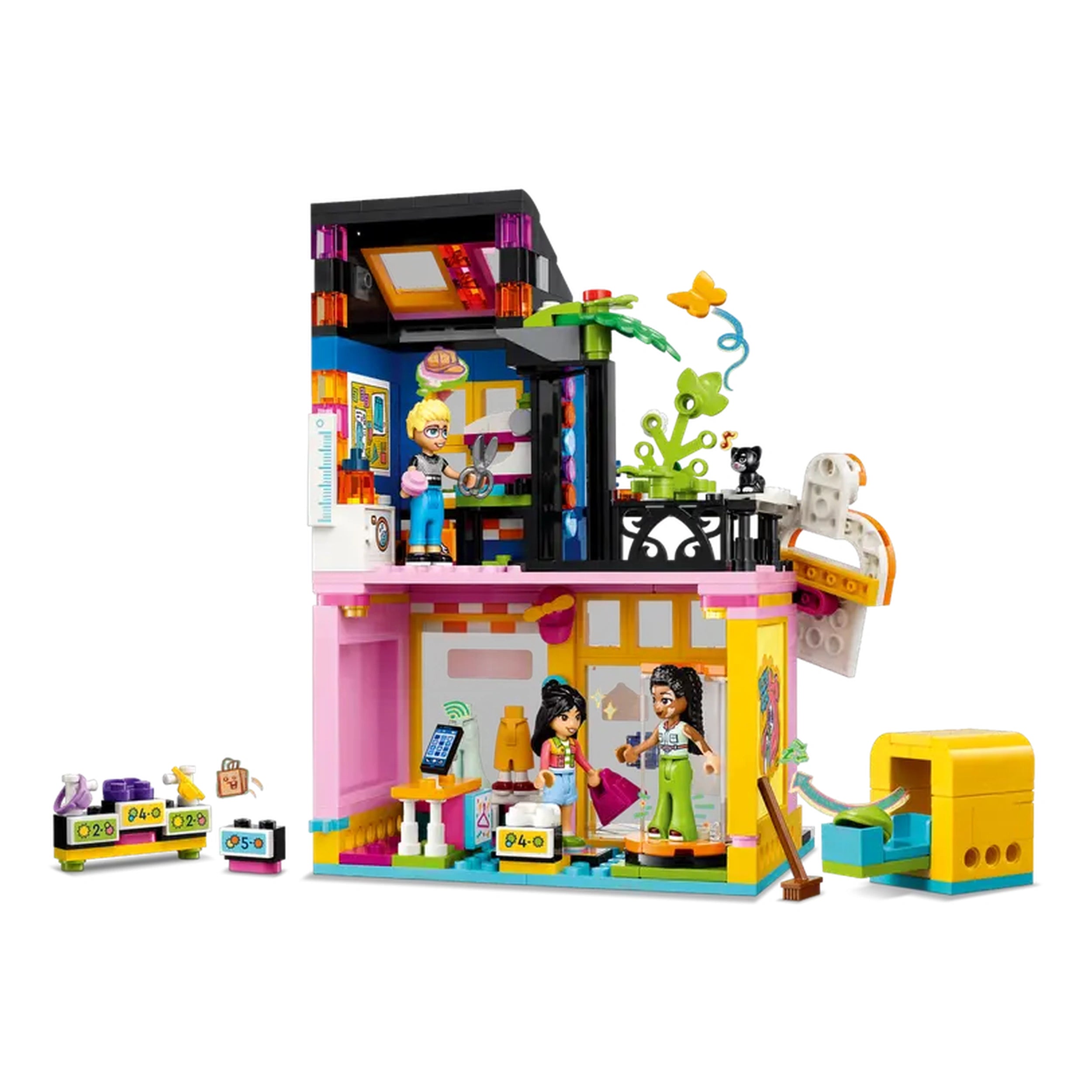 LEGO Friends Vintage Fashion Store set featuring three characters, a cat, and vibrant interiors with a washing machine and sewing machine.