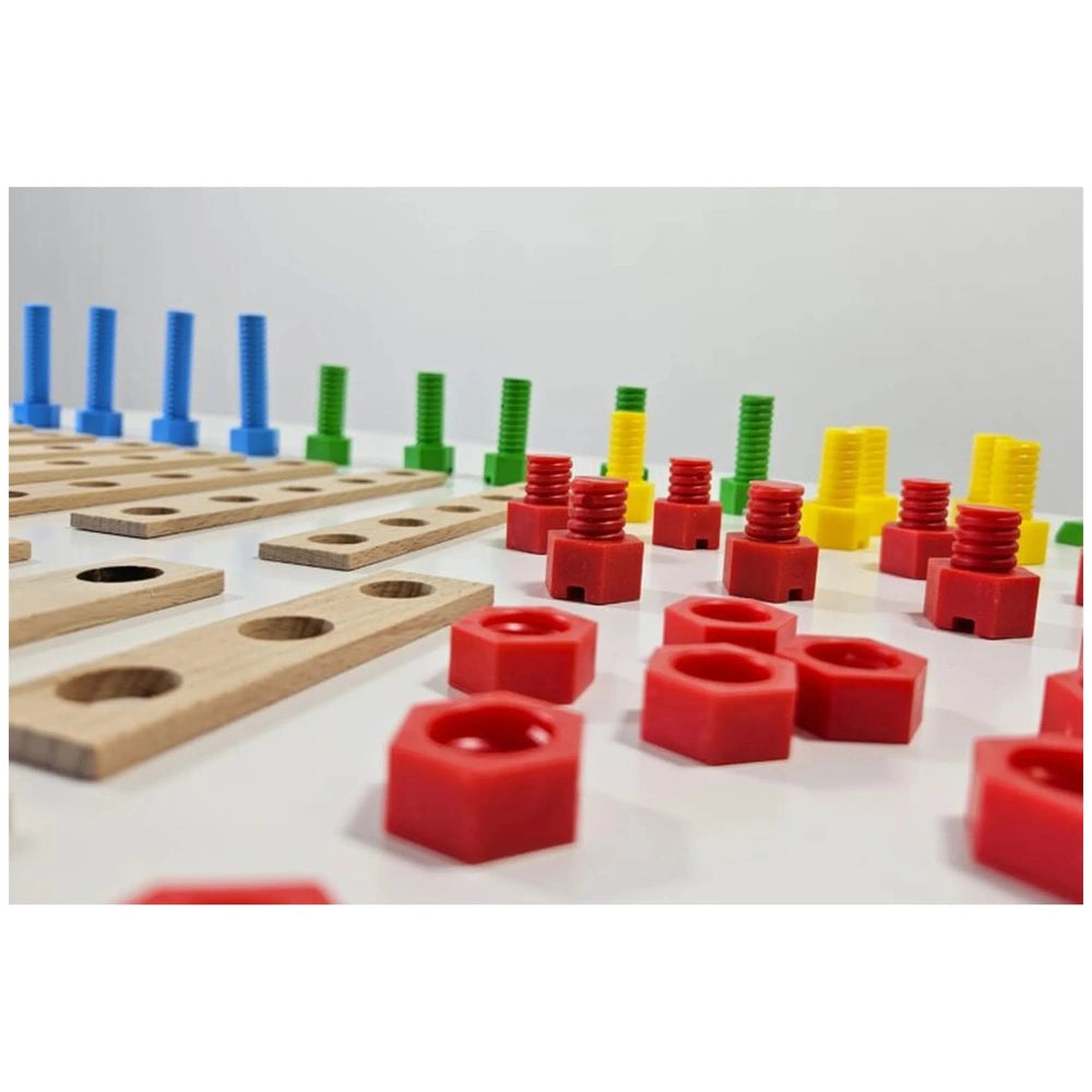 Colorful screws and connectors with wooden boards from the Alexander Constructor Junior set on a white surface.