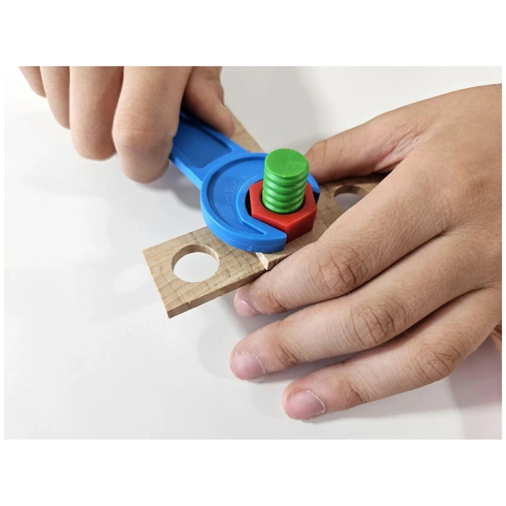 Child assembling wooden planks with colorful screws using a blue wrench from Alexander Buggy Construction Set.