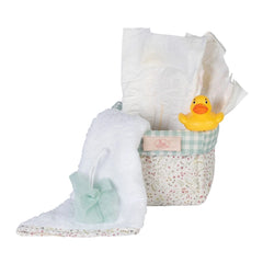 Quilted floral basket with diapers, a white towel, small tulle sponge, and yellow rubber duck for 36-50 cm dolls.