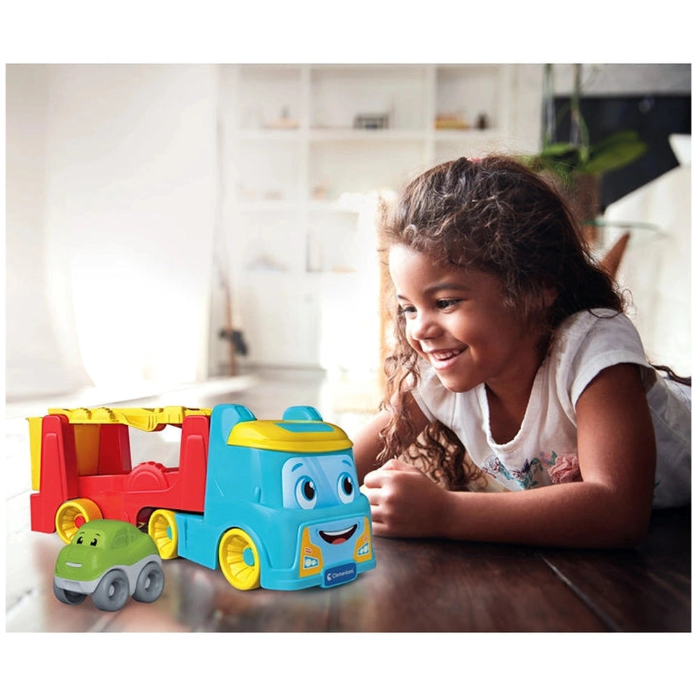 Baby Clementoni 2 In 1 Tumbling Cars Transporter activity toys are featured with a smiling girl on a wooden floor.