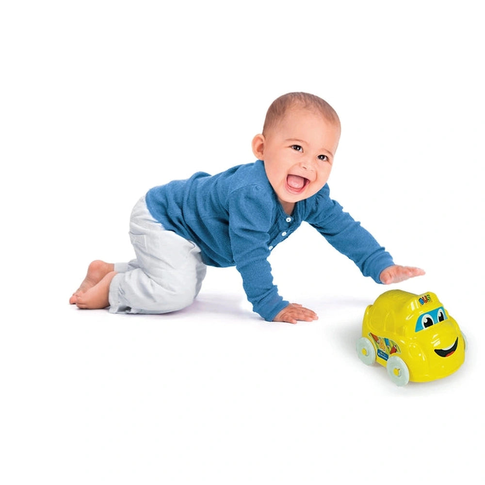 Baby Clementoni toy features a smiling face and wheels, as a toddler joyfully plays on a light-colored floor.