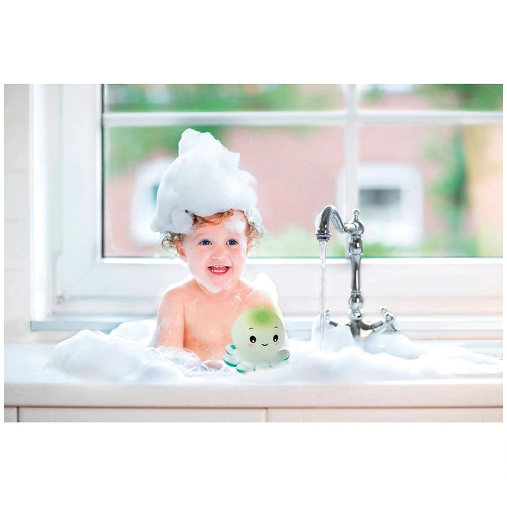 Baby Clementoni Octo Baby Bath Toys are held by a smiling child with wet red hair in a bubbly white bathtub.