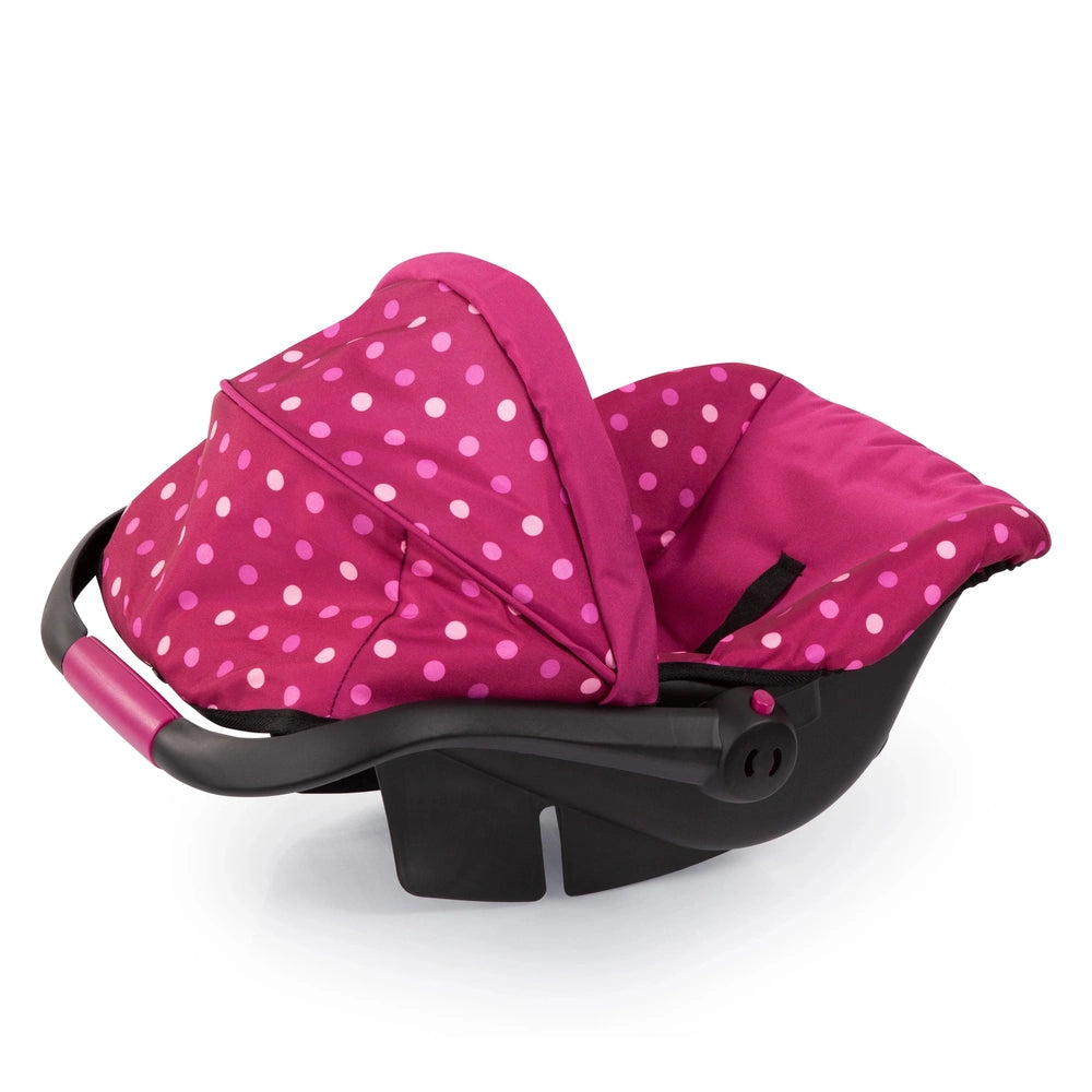 BAYER DESIGN Doll Deluxe Car Seat features pink fabric with white polka dots and a black plastic frame with pink trim.