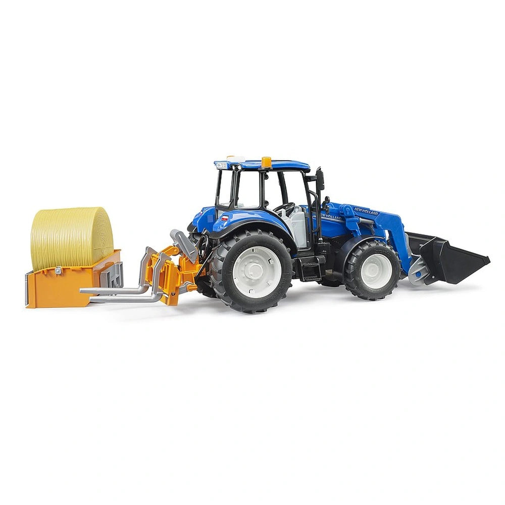 Blue New Holland T5.120 toy tractor with front loader and dump box, attached to a yellow bale fork.
