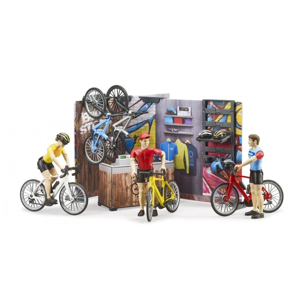 Toy bike shop scene with three figures cycling, colorful display of helmets, and bike accessories in a vibrant setting.