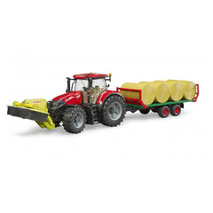Red Bruder Case IH Optum 300 CVX toy tractor with trailer carrying four yellow hay bales, detailed and realistic design.