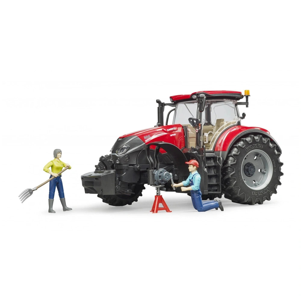 Red Bruder Case IH Optum 300 CVX toy tractor with figures, one kneeling near the front and one holding a pitchfork.