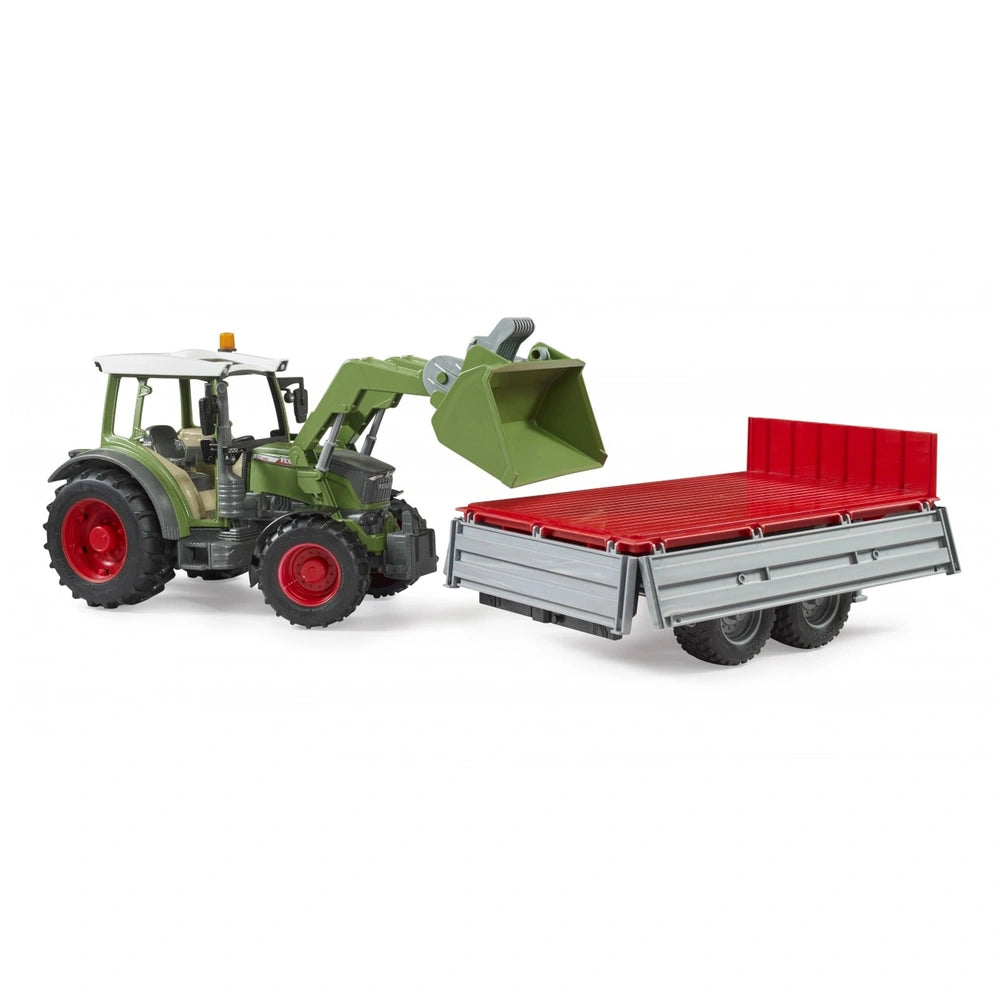 Green toy tractor with frontloader attached to a red and gray tipping trailer, showcasing realistic farm vehicle design.